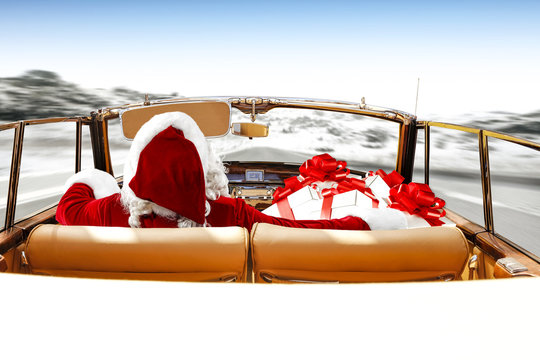 santa claus in cabriolet on winter road 