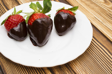 strawberry in chocolate over white background