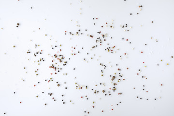 scattered pepper on white surface
