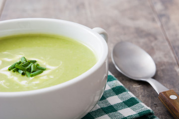 zucchini soup in bowl on wooden table