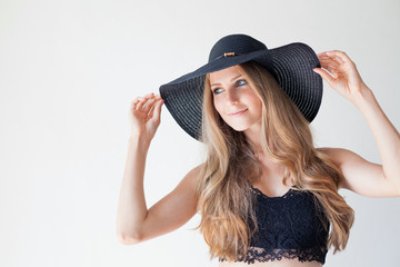 Portrait of fashionable girl in hat with large fields