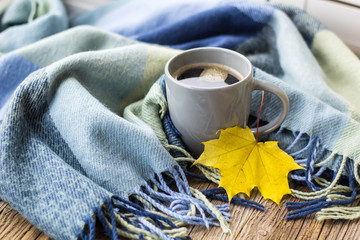 still life a cup of coffee and autumn leaves with plaid