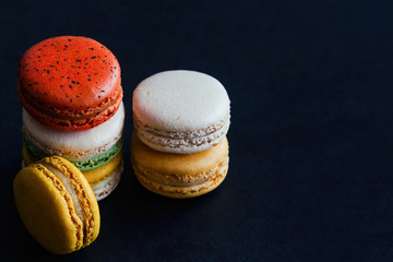 Close up colorful French macaron or Italian macaron, French dessert for served with tea or coffee. Homemade delicious macaron on granite table with copy space for isolated background or wallpaper.