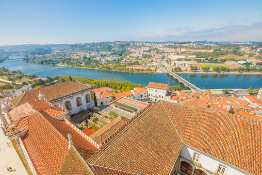 Coimbra cityscape and Santa Clara Bridge on Mondego river. Coimbra in Central Portugal, is famous for its University. Coimbra aerial view from bell clock tower in a sunny day.