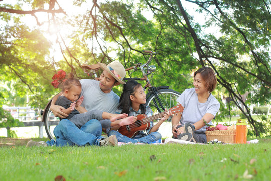 Happy Asian Family Picnic Togetherness Relaxation Concept