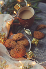 cozy Christmas and winter setting with homemade cookies, coffee, lights and New Year decorations. Baking at home on weekend.