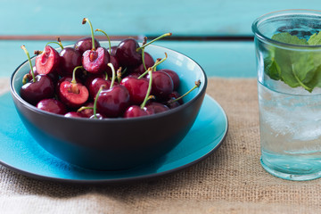 Fresh cherries in a blue bowl