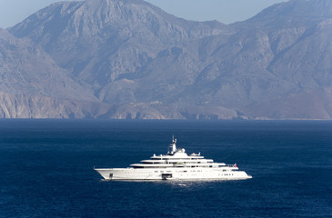 A super yacht at anchor on the Gulf of Mirabello off the Cretan town of Agios Nikolaos, Crete,...
