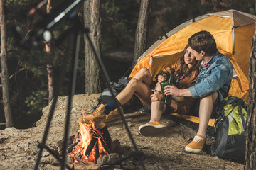 couple on hiking trip drinking beer