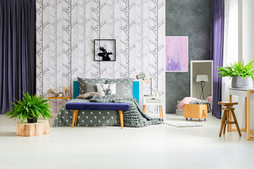 Birch tree wallpaper above bed