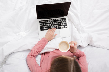 woman with laptop in bed