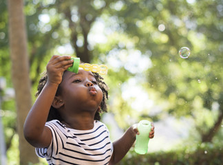 African kid playing with bubbles
