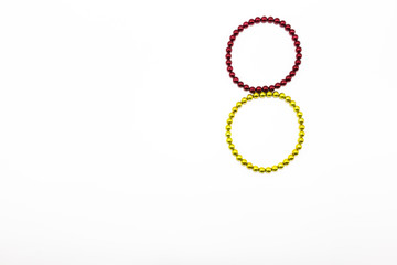 Yellow and red sphere magnetic in loop shape on the white background