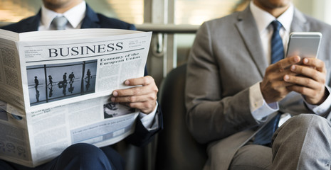 Business Men Break Sit Read Newspaper - Powered by Adobe