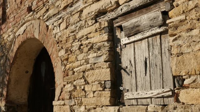 Abandoned stone building details footage - Old wine cellar window and door 