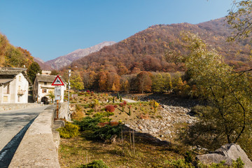 Piedicavallo, Italy - October 20, 2017: Rustic alpine houses and bridge in the village of...