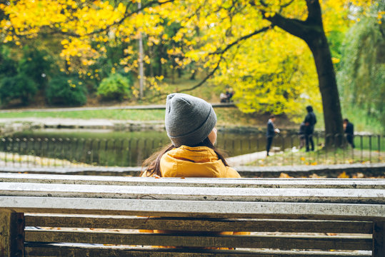woman sitting on a banch in city park