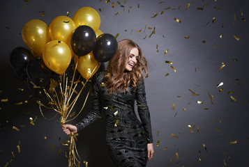 Joyful woman with bunch of balloons