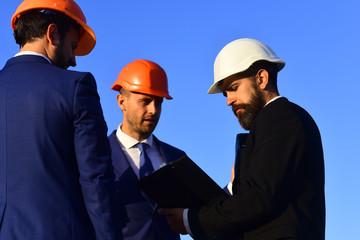 Constructors hold clip folder. Building and engineering concept.