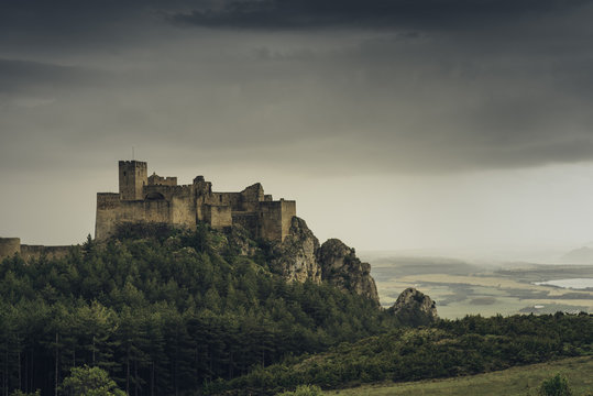 Medieval  castle in the hills on a cloudy day.