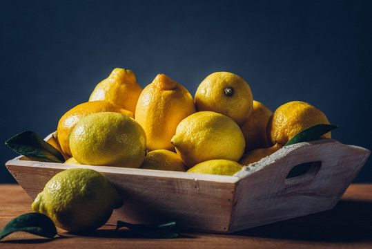 crate with lemons on table