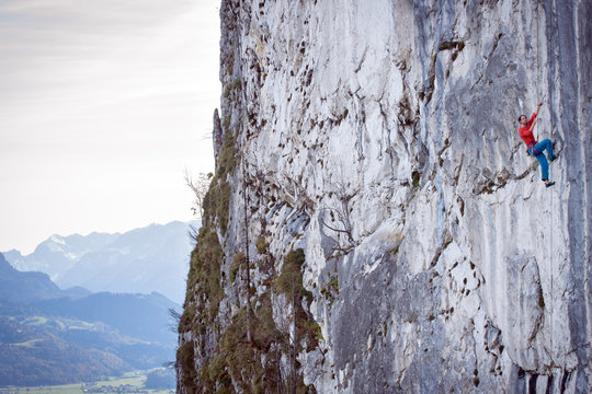 A mountain climber is hanging on the wall of the one of the Barmsteine rock towers, which are part of the Hassel Mountains in the Bavarian Alps between Austria and Germany.