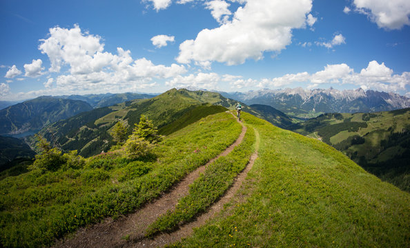 A Mountain Biker Rides His Bike In A Beautiful Landscape Near Zell Am See At The Kaprun Region, Austria.