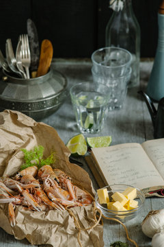 Langoustines on kitchen table with recipe book.