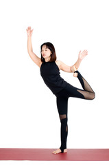 middle aged asian woman doing yoga in Natarajasana or Lord of the Dance Pose yoga pose on the mat isolated on white background, exercise fitness, sport training, healthy lifestyle and people concept