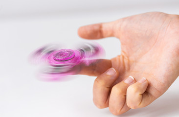 close up of hand playing with fidget spinner