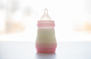 infant milk formula in baby bottle on table