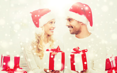 happy couple at home exchanging christmas gifts