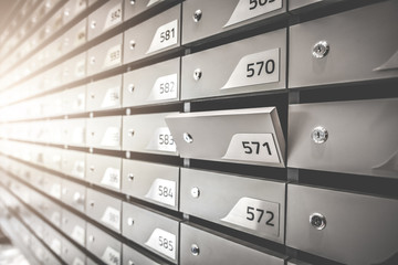 Mail boxes filled of leaflets and letters. Shallow DOF,Mailboxes and Lock in Rows at Entrance.