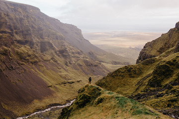 Naklejka premium An Adventure Hiker in an Iceland Canyon Wide View of the Landscape