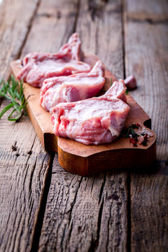 Raw fresh meat Veal rib Steak on bone  on a wooden vintage background with spices and rosemary