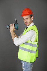 Builder holding a drill like a gun