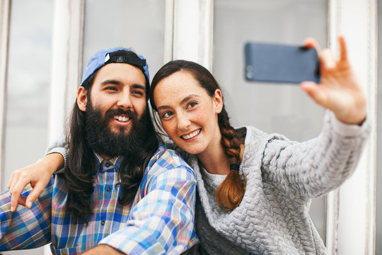 Young hipster friends making a selfie in outdoors.