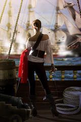 pirate captain in sexy clothes calmly stands on the deck of her ship under enemy fire and waits for...