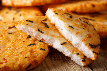 spicy rice cracker with seaweed macro on the table. horizontal