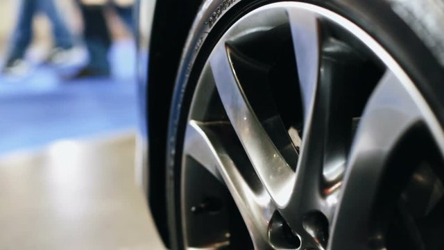 Sale of cars in the showroom, closeup of the car wheel