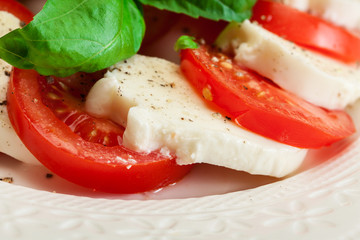 Caprese salad with mozzarella, tomato, basil