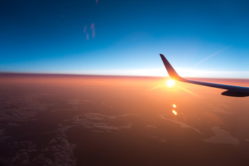 Sunset from a plane with the wing