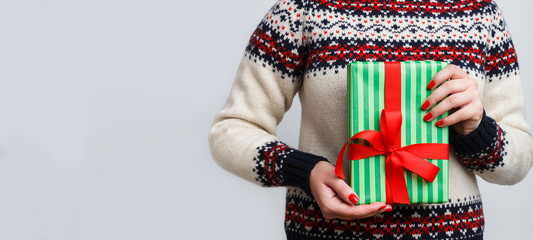 Unrecognizable woman holding christmas gift