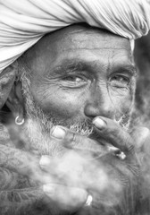 Indigenous Indian man smoking happily.