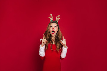 Shocked young woman wearing christmas deer costume.
