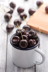 Cherries on wooden table with water drops background