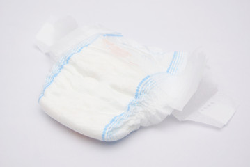 Disposable Baby Diapers Over White Background
