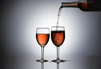 Pouring rose' wine in a glass.