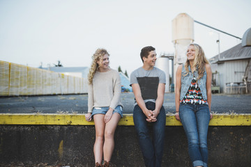 Group of real teens enjoying hanging out together outside