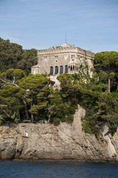Portofino, Liguria Italia -  watching the coast from the sea. View of the Paraggi Clastle , Villa Bonomi, residenza di Silvio Berlusconi, near Portofino with crystalline waters